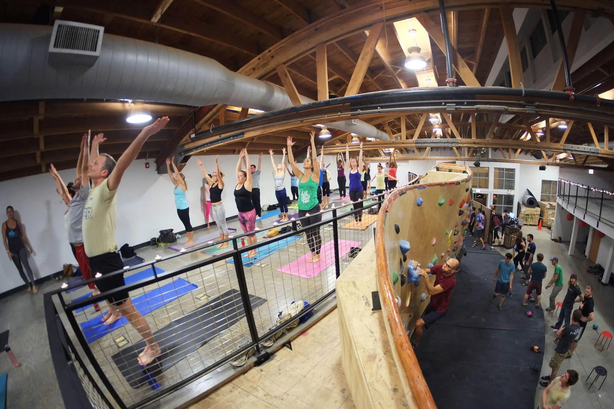 More efficient use of an inspirational space by BKB and Vertical Solutions - A breakout yoga class atop the mezzanine where bouldering takes place below. Details like this handcrafted hardwood top-rail on the ARC bouldering wall is just one of the many things that can set your gym apart from the rest.