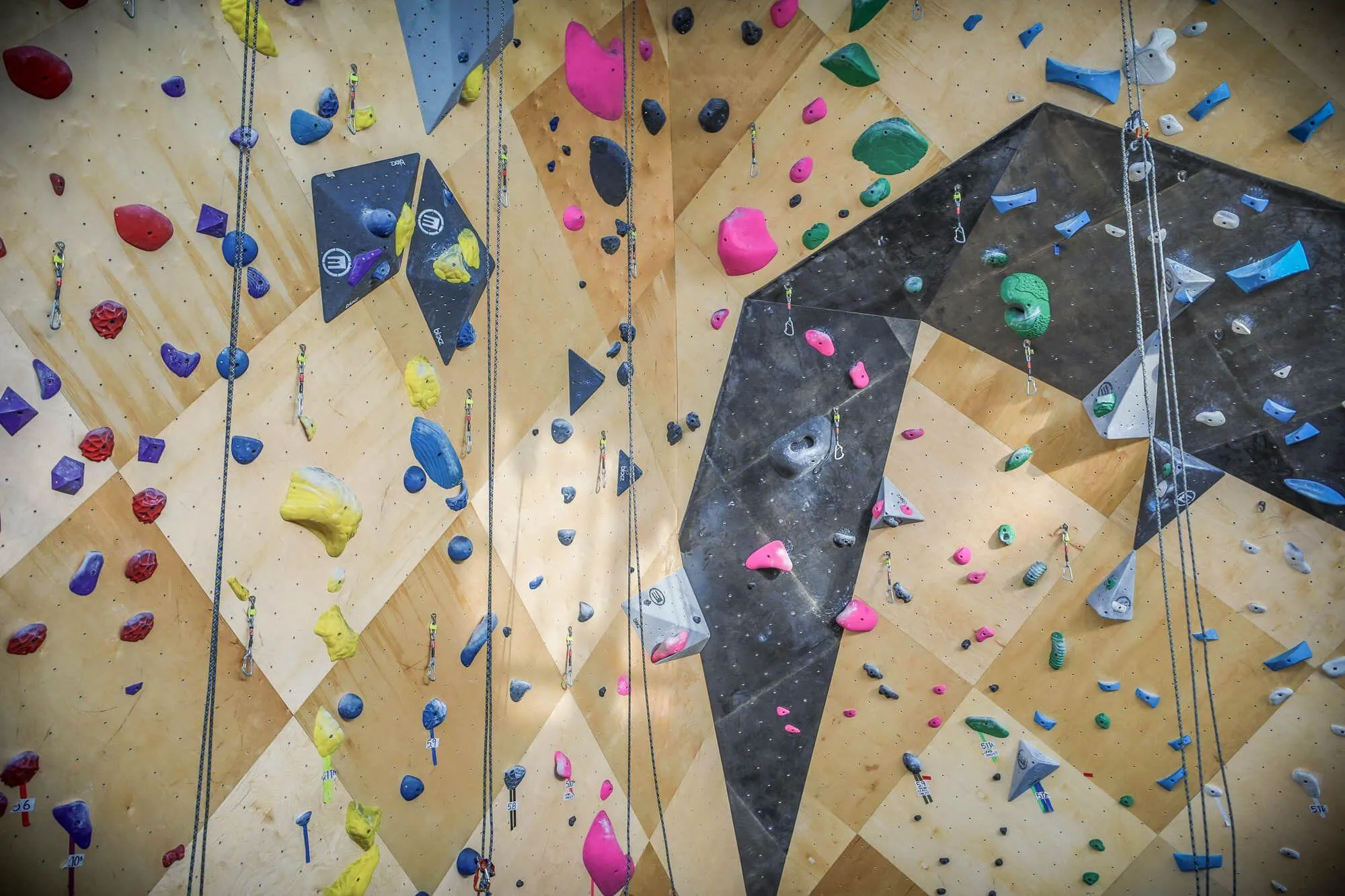 A closer view of the newly renovated indoor route climbing walls from Vertical Solutions. Hard to see from this angle but the custom black stain highlights a crafty overhung feature.