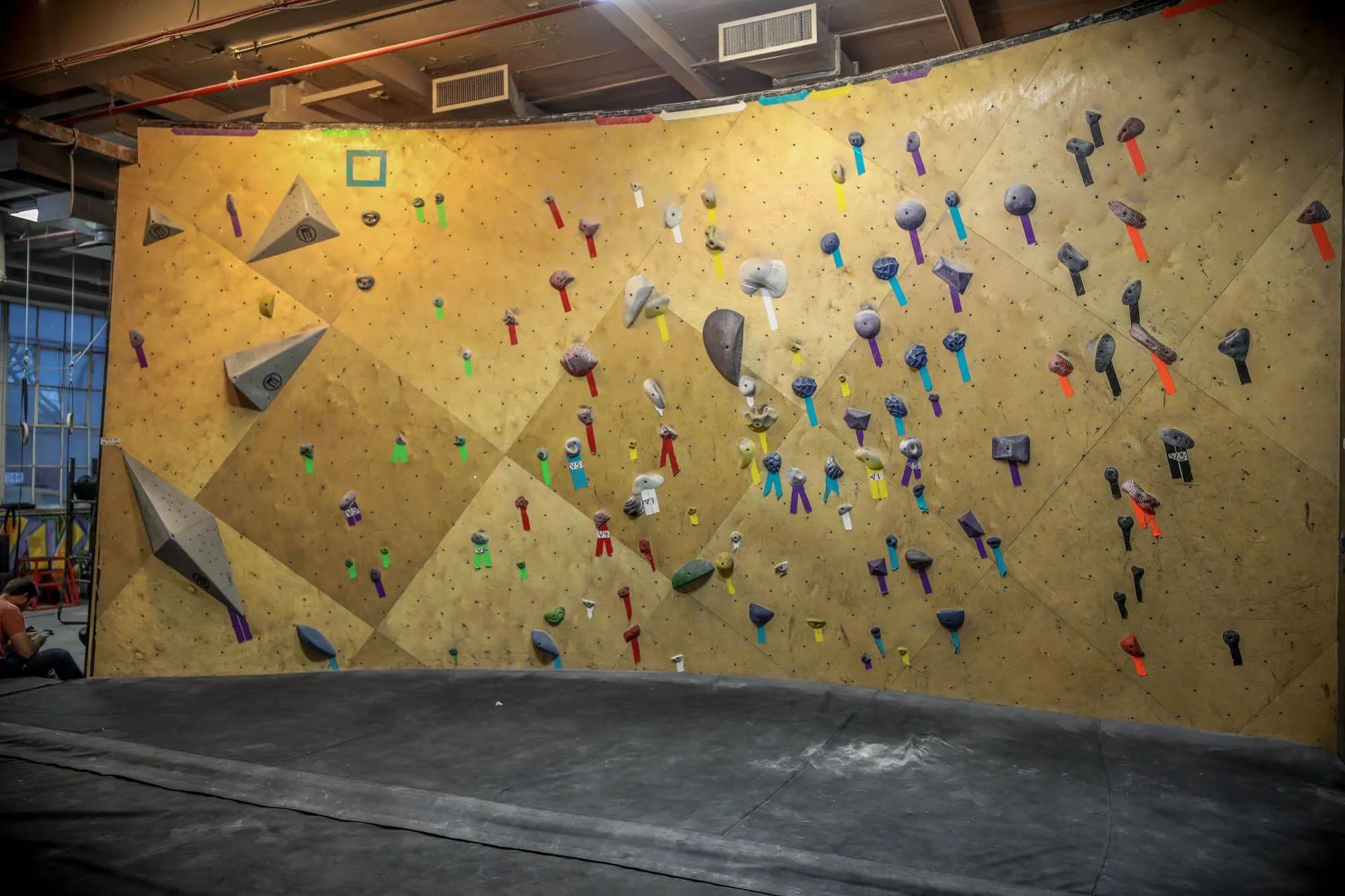 Beginner and intermediate bouldering members get their own dedicated space to familiarize themselves without being overwhelmed by others above their skill level. This Vertical Solutions-built wall is coupled with Habit Flooring system for a complete package.
