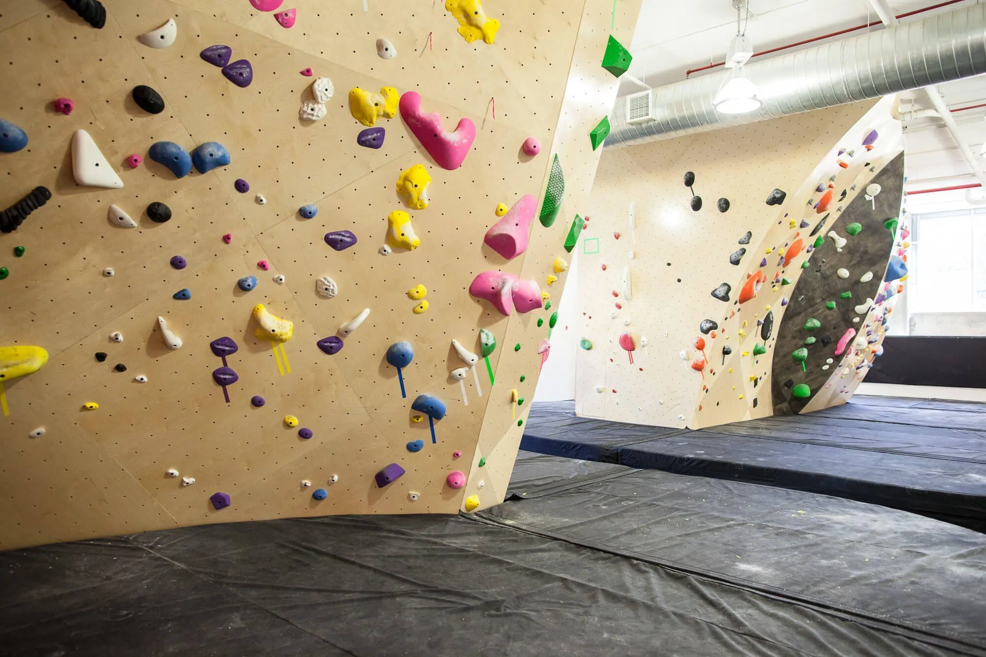 Another view of the indoor climbing wall areas that were designed precisely to maximized climbing square footage and maintain good accessibility.