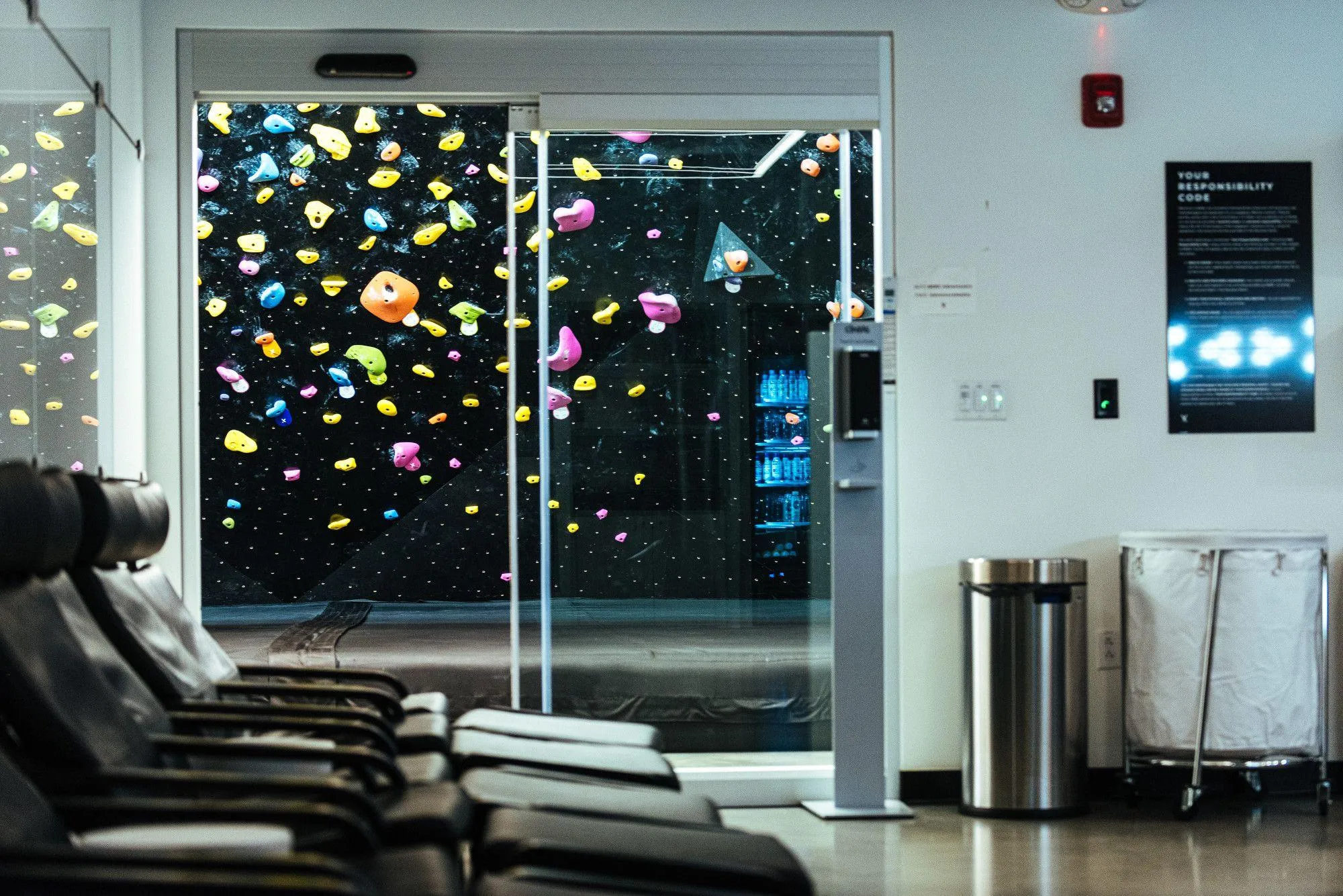 A view of the bouldering wall from the Recovery Room.
