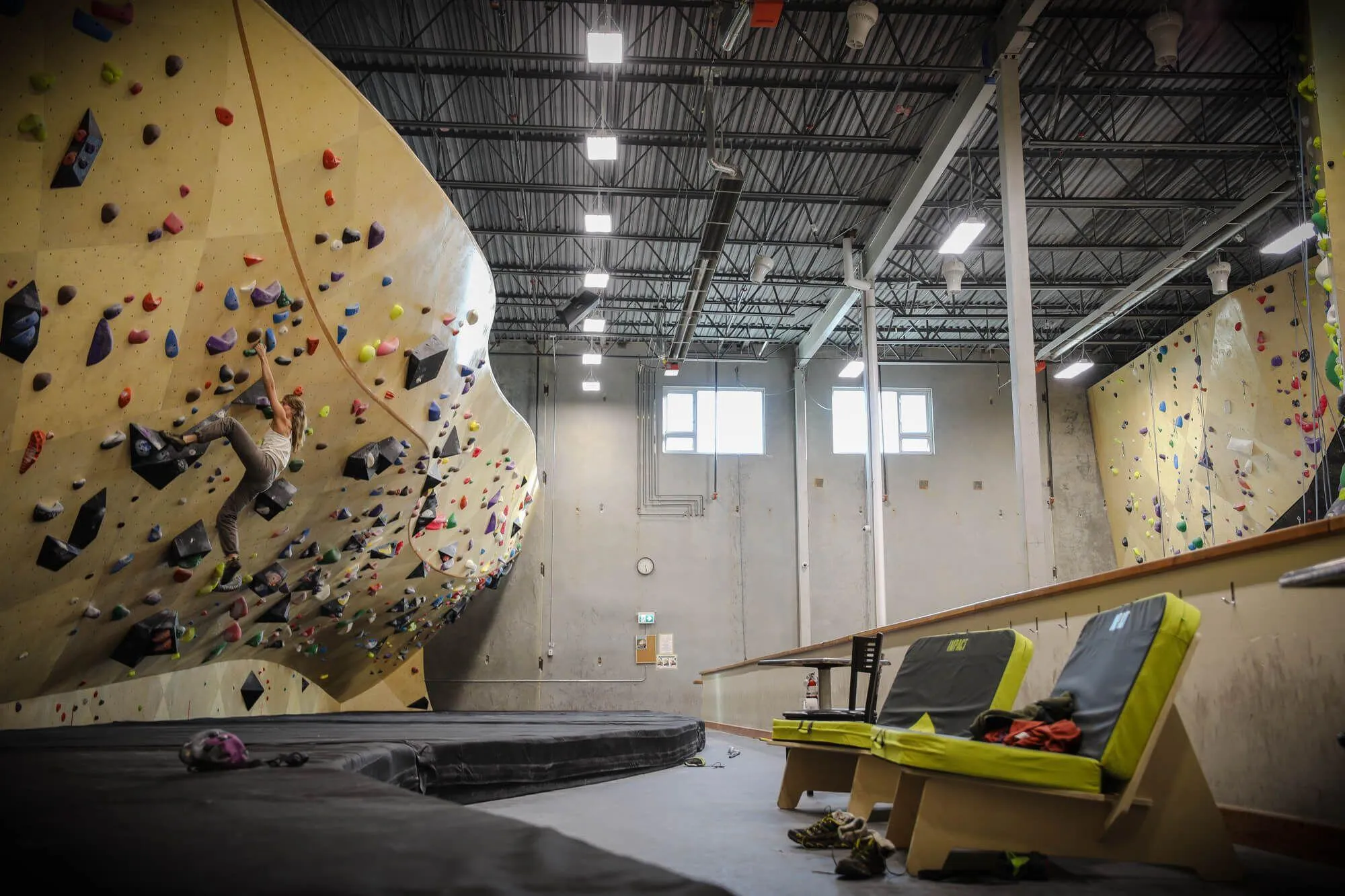 A down low view of the lengthy bouldering area on the mezzanine level. Habit Flooring has their climbers’ backs on falls all the way up to the 16’ top-out. In the foreground, you can see some custom benches VS built to use Black Diamond crash pads.