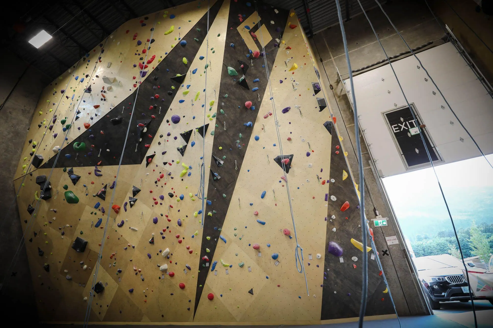 In-between the two lead walls and tower, is a bridge to the outdoors to quickly remind climbers exactly where they are at. The cool and crisp air of one of climbing’s classic areas rushes in via large garage door strategically located to introduce natural light as well.