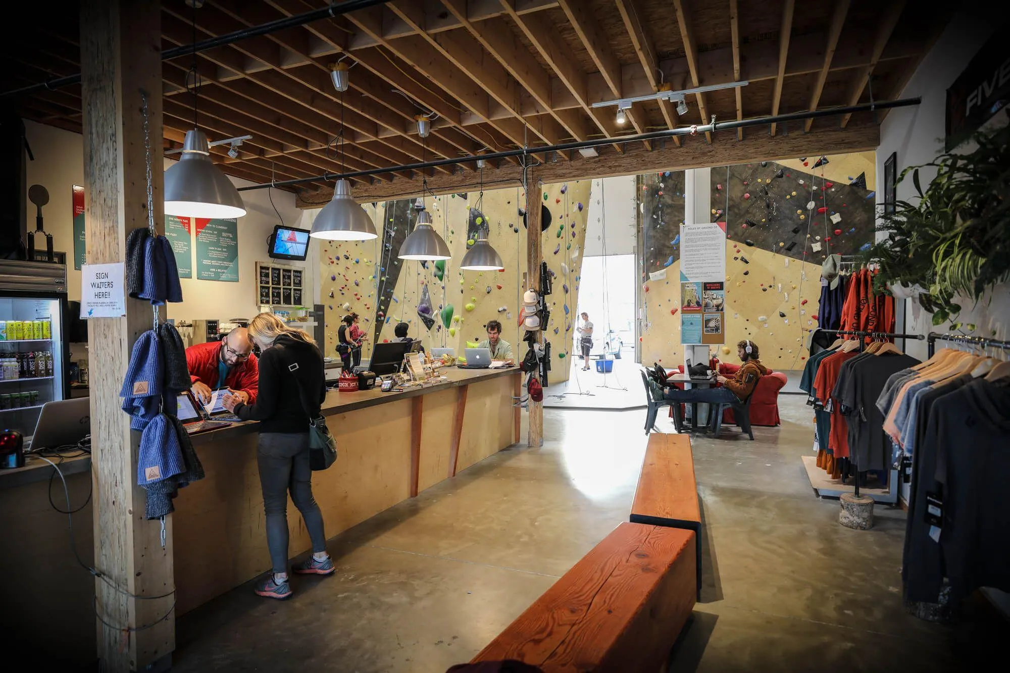 The entry view of this climbing gym, which remains open and airy for customers to check-in, browse the new merch, get some deets on upcoming clinics or relax with an americano.