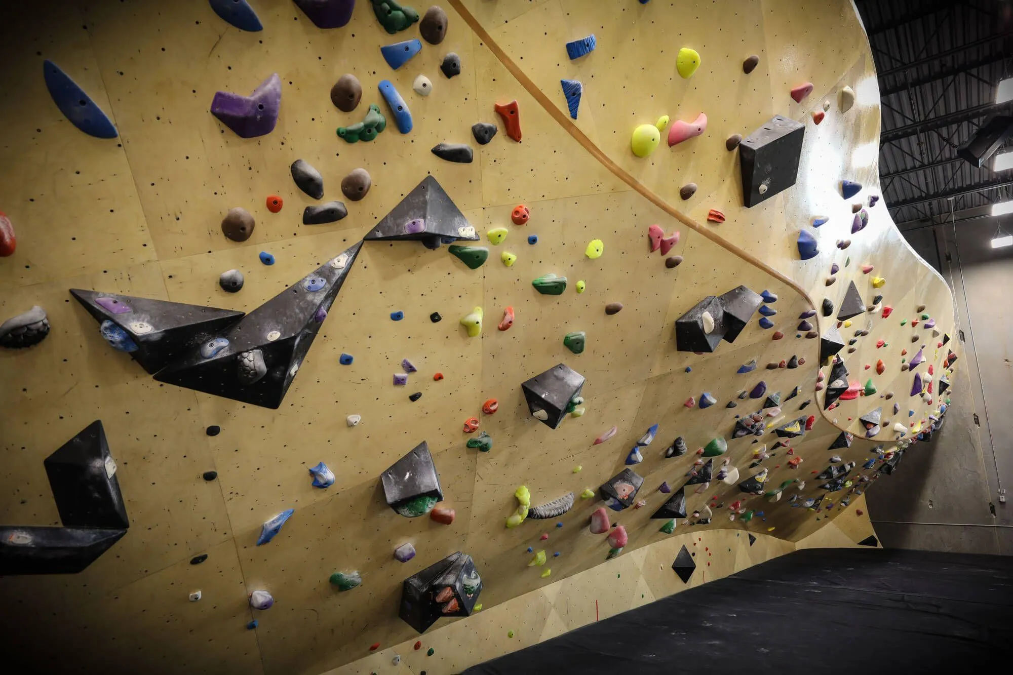 ARC walls designed and built by Vertical Solutions play nicely with volumes built by any brand. Our curved walls still maintain enough contact area for your routsetters to consistently create new problems using volumes. The non-destructive nature of our layer system means screw holes left over will not propagate.