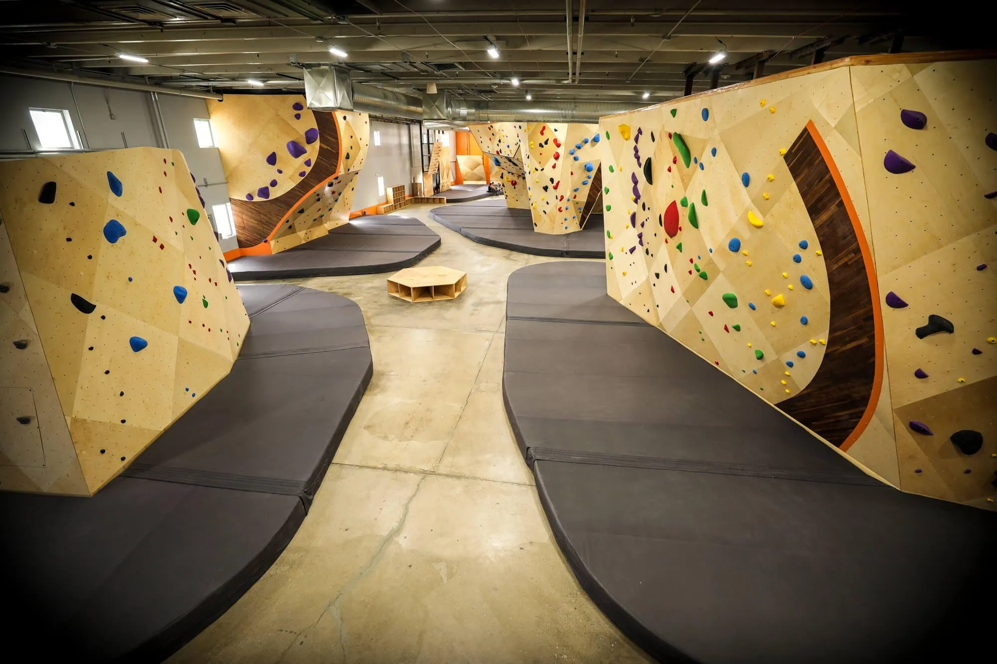 The view from the mezzanine looking lengthwise down the whole facility, which consists of freestanding boulders and climbing walls tied into exterior walls, almost equal in portions.