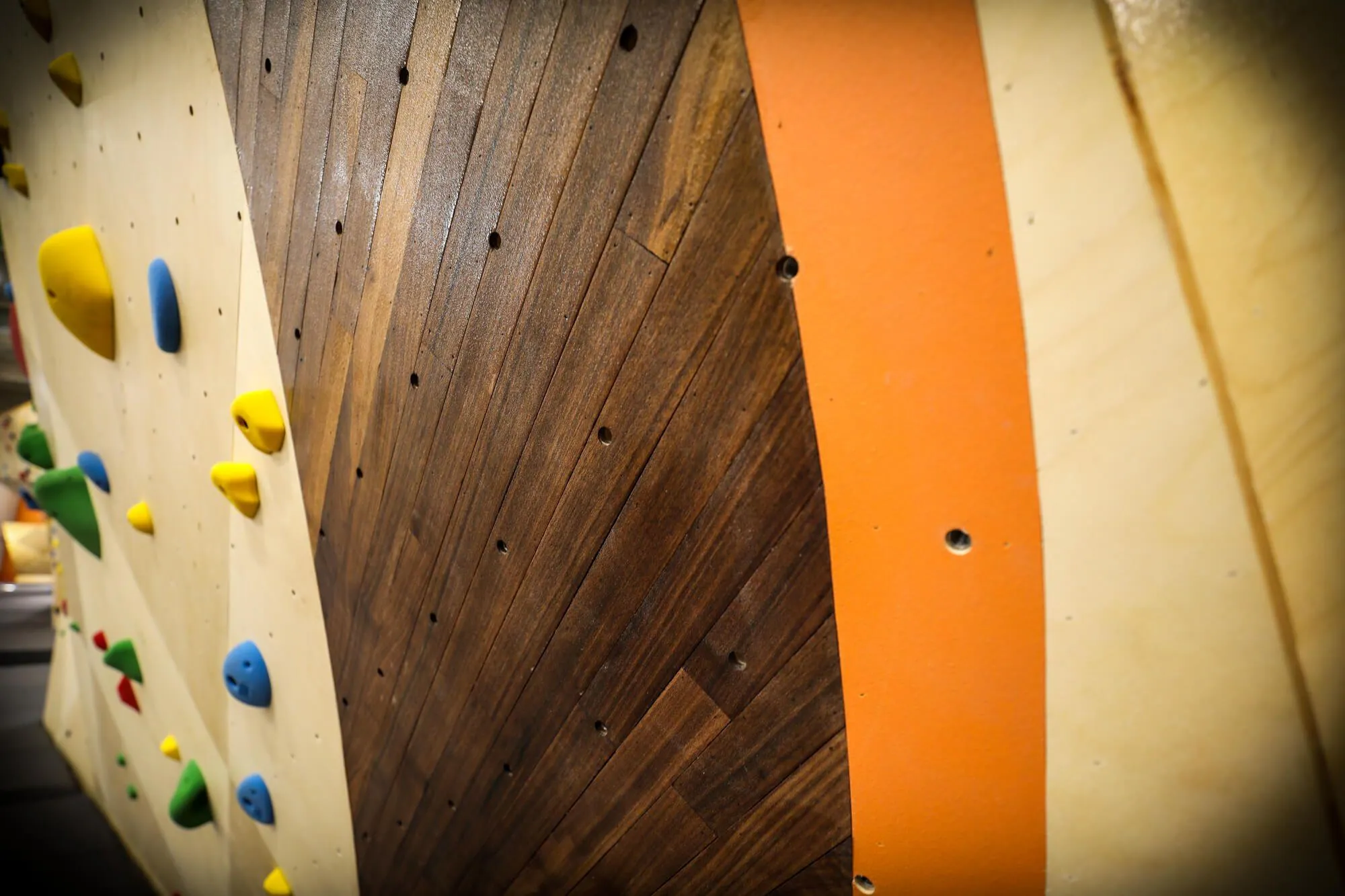 A close up detail of the warm and rich hardwood accents, as well as how precise the VS team manufactures climbing walls. All surfaces come together seamlessly, and holes spanning two surfaces are executed with no lack in finish appearance or accuracy.
