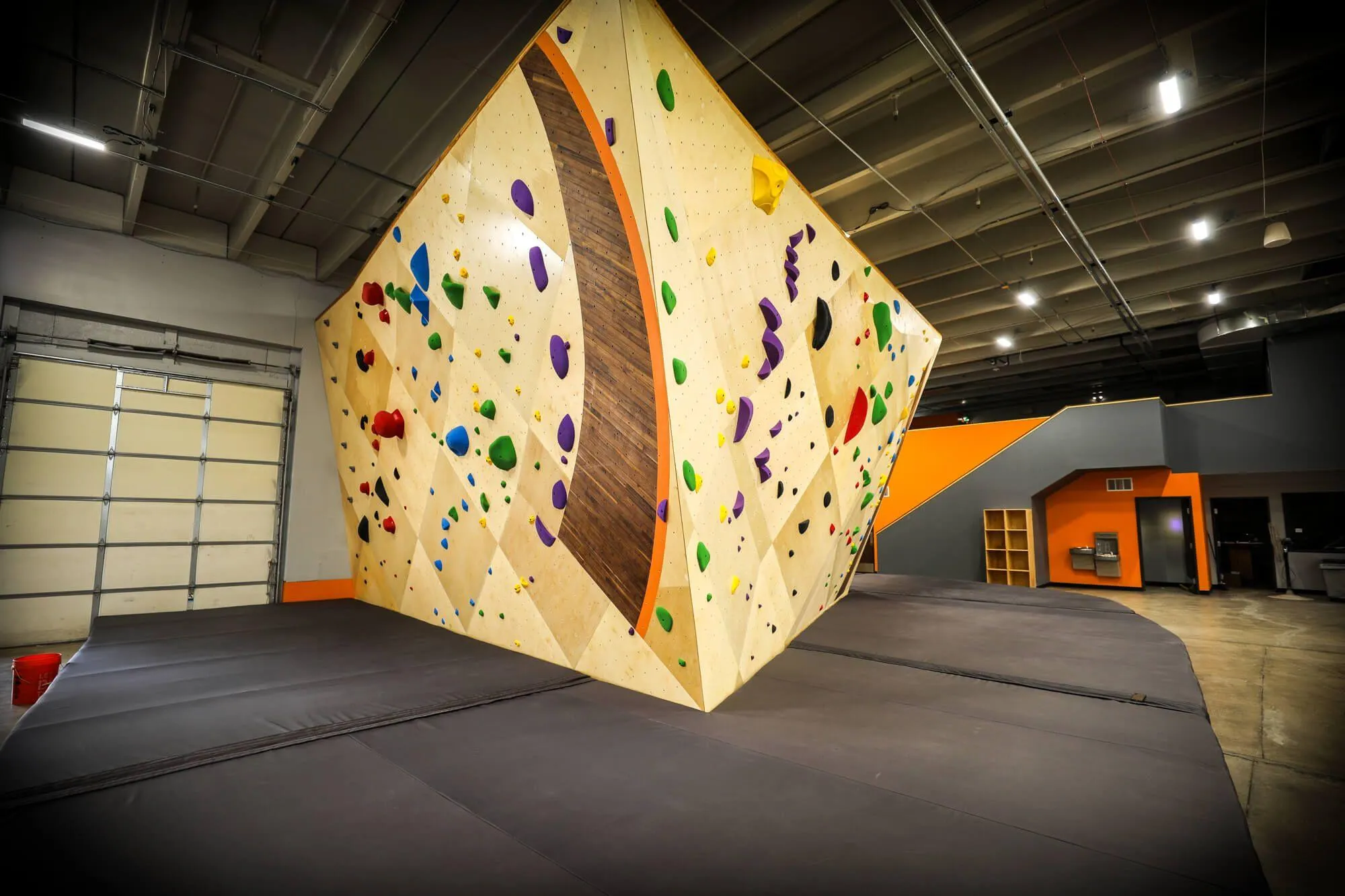 Another building-anchored boulder, this one being MLM constructed with faint but purposeful angle changes. The mezzanine in the background leads to an event space and yoga room.