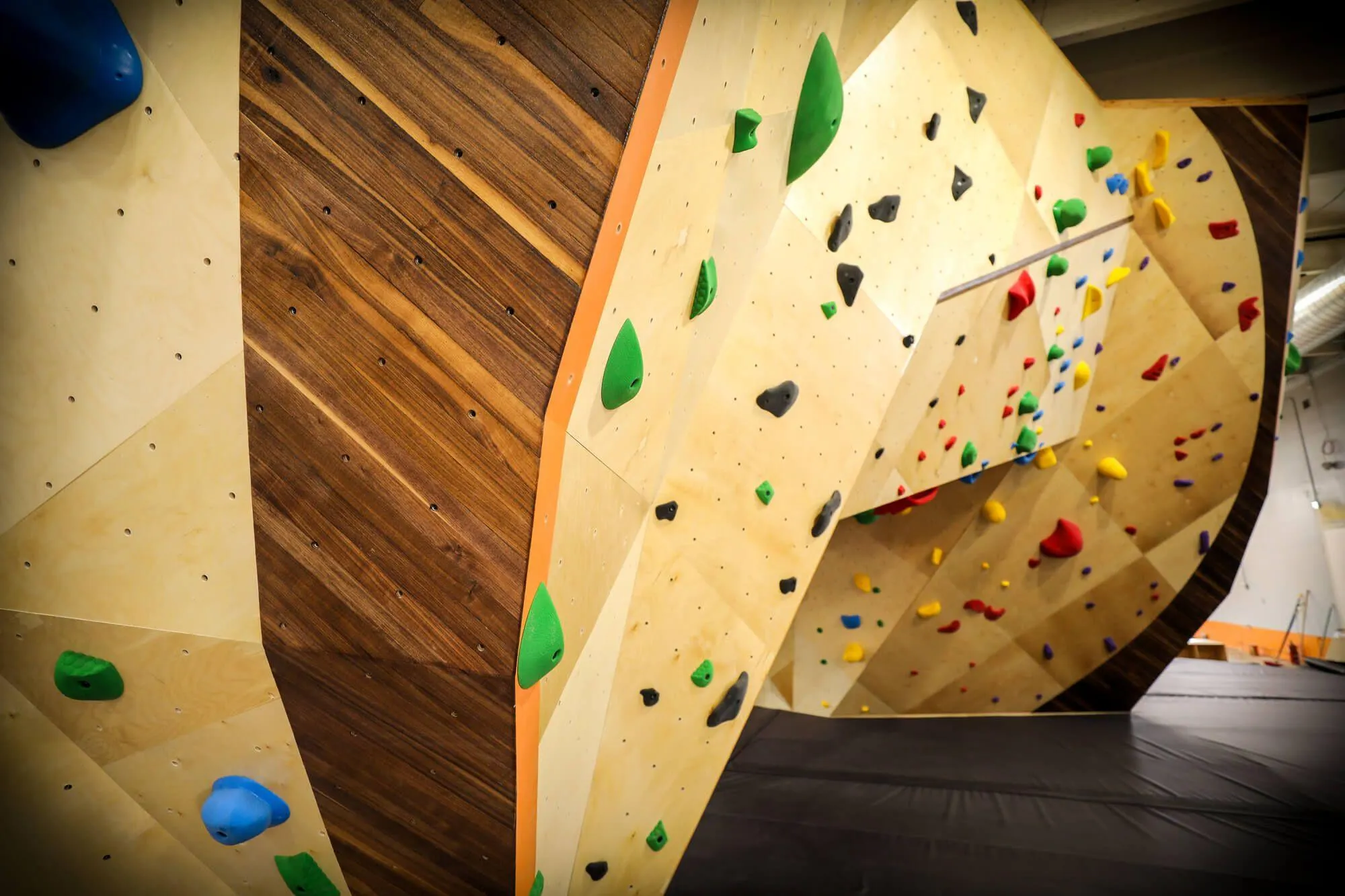 The central boulder at this gym is not only gigantic, but also extremely detailed as seen here with this stunning hardwood inlay section lining & defining an primary edge.