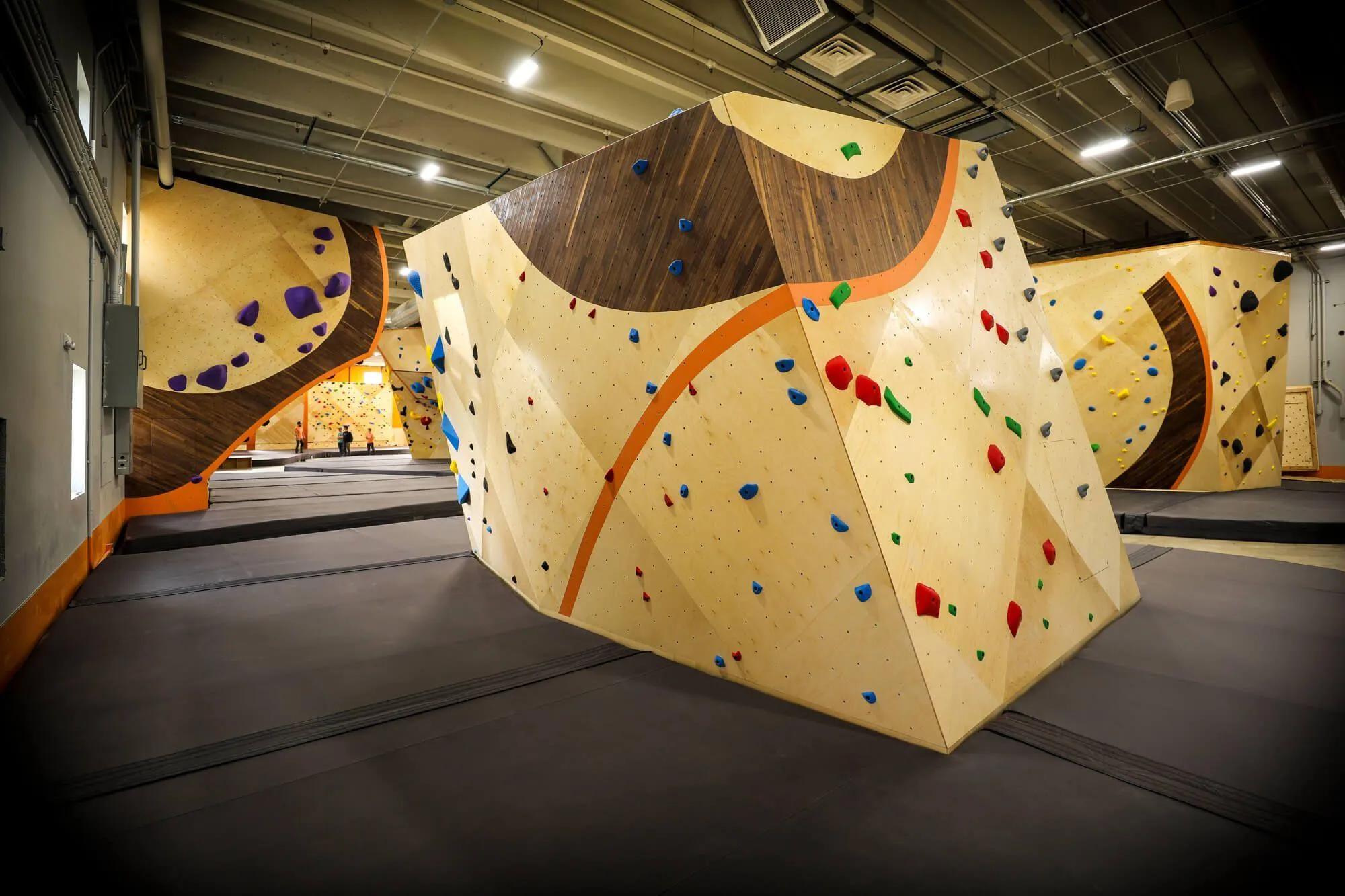 A smaller freestanding boulder towards the front of the climbing gym features a higher percentage of beginner bouldering terrain, while lacking nothing in style and appearance. This is a great example of how important it is to have your architectural, climbing wall and flooring designs aligned to create the perfect fitment onsite.