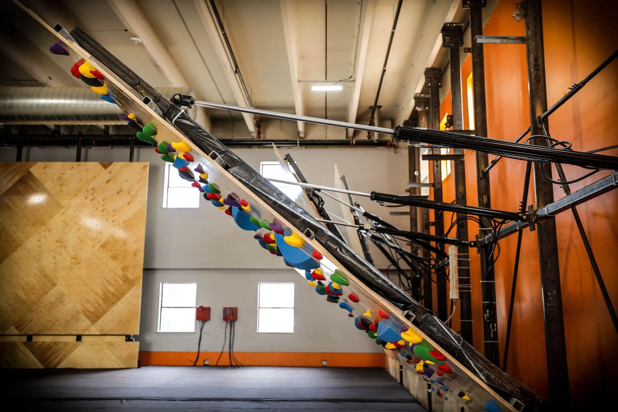 A side-view of ATP adjustability (Adjustable Training Platform), and its quick-adjust hydraulics which carry the heavy-lifting. LCC has a total of 4 adjustable walls, all in different climbing wall square footage offerings.