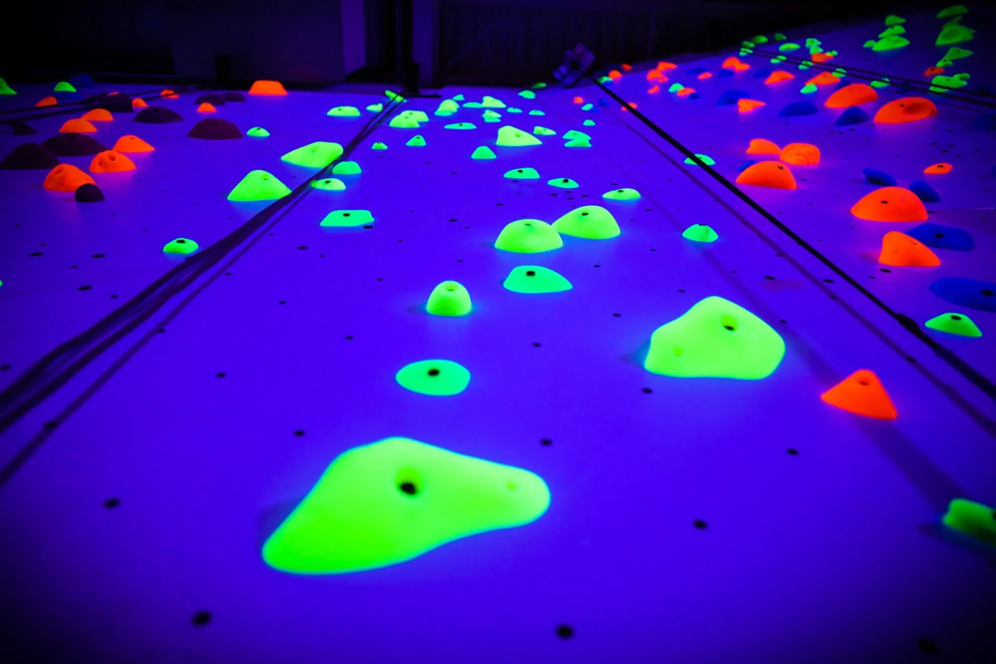 We worked to coordinate this project with our sister company, Proxy Climbing, to manufacture holds specifically for Rush Funplex that reacted to the multitude of black lights installed. Since we are a single-source for all things indoor climbing, this process was made incredibly easy for our clients and they didn't have to deal with multiple companies to execute on their vision.