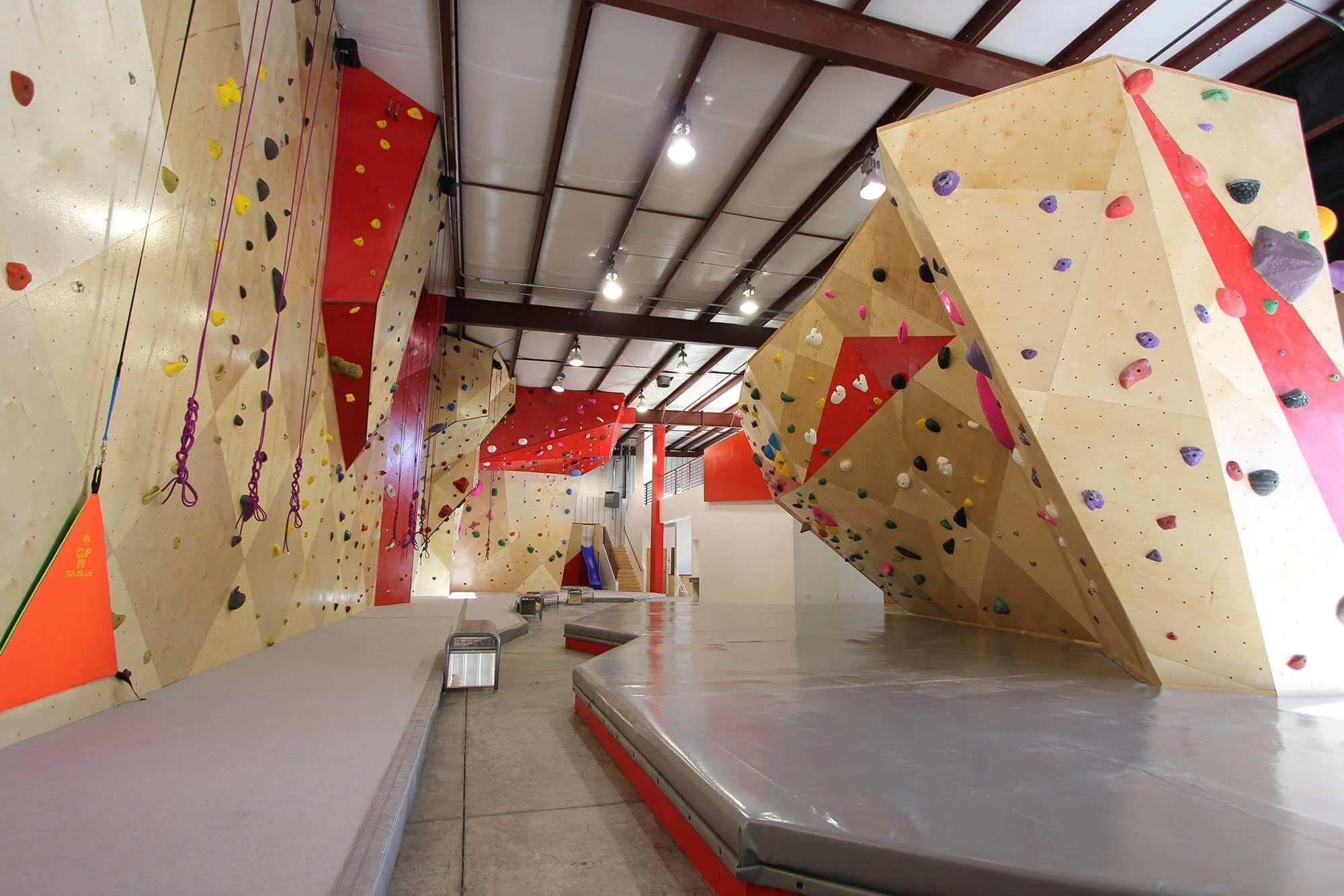 A really great perspective on the whole facility, with the rope-climbing all along the left and large indoor bouldering walls on the right of the image. All of these climbing wall systems were manufactured and built by Vertical Solutions and we couldn’t be happier with how it turned out.