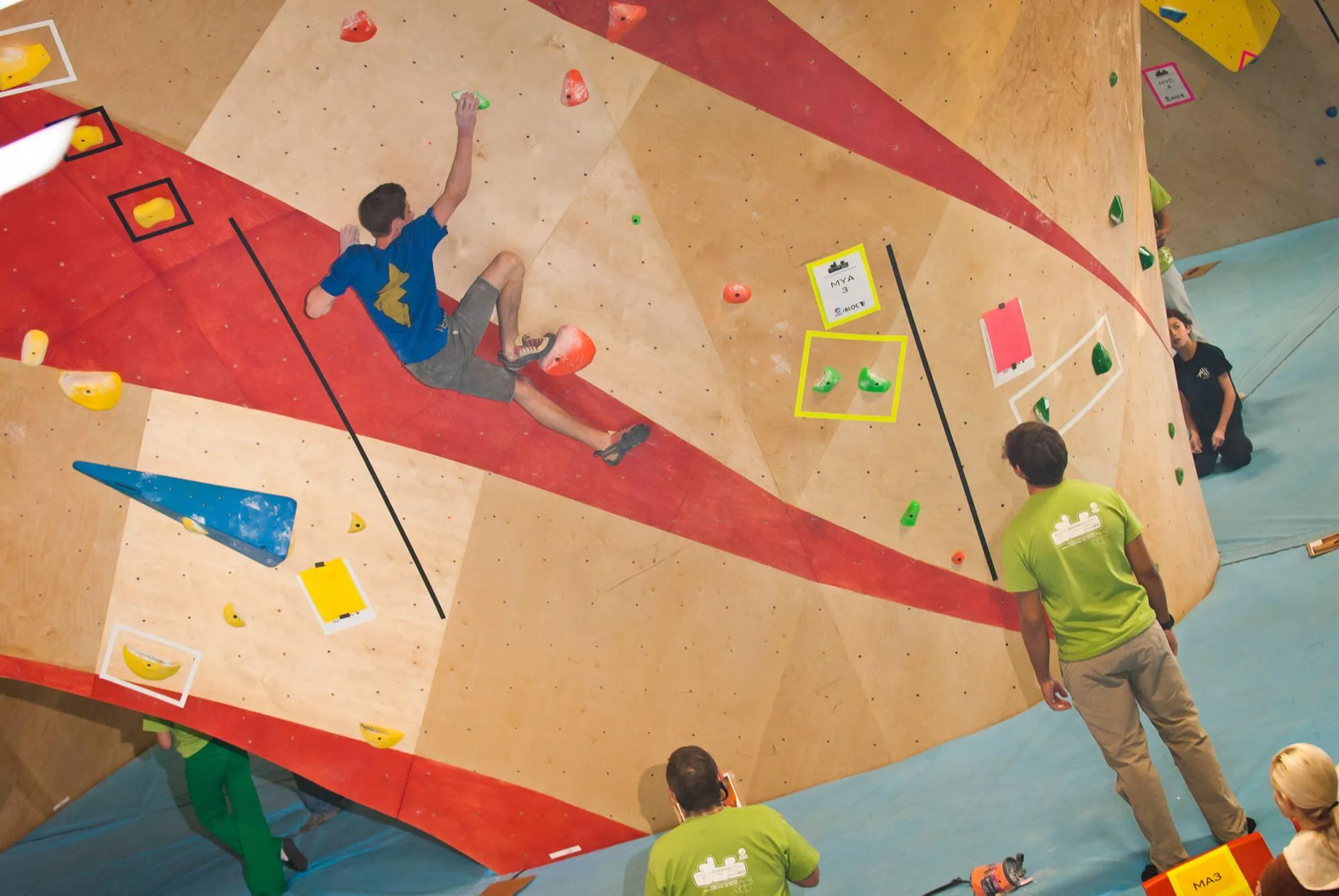 This is a good up-close image of how custom color can add to your climbing wall design, either with paint, or with stain as seen here which keeps much of the original birch hardwood grain visible.