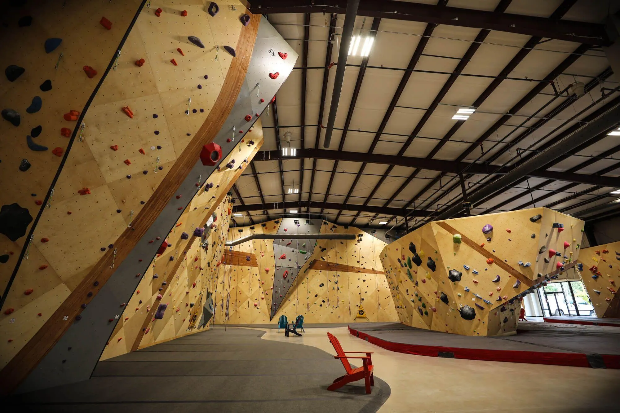 One wide-angle view of how much climbing this facility really offers, it's hard to believe this is actually only just over half of it in-view. The boulder on the right was a special interest of the owner's, as outdoor bouldering in the area commonly sees intimidatingly-overhung problems. It was a must-have feature during the design phase.
