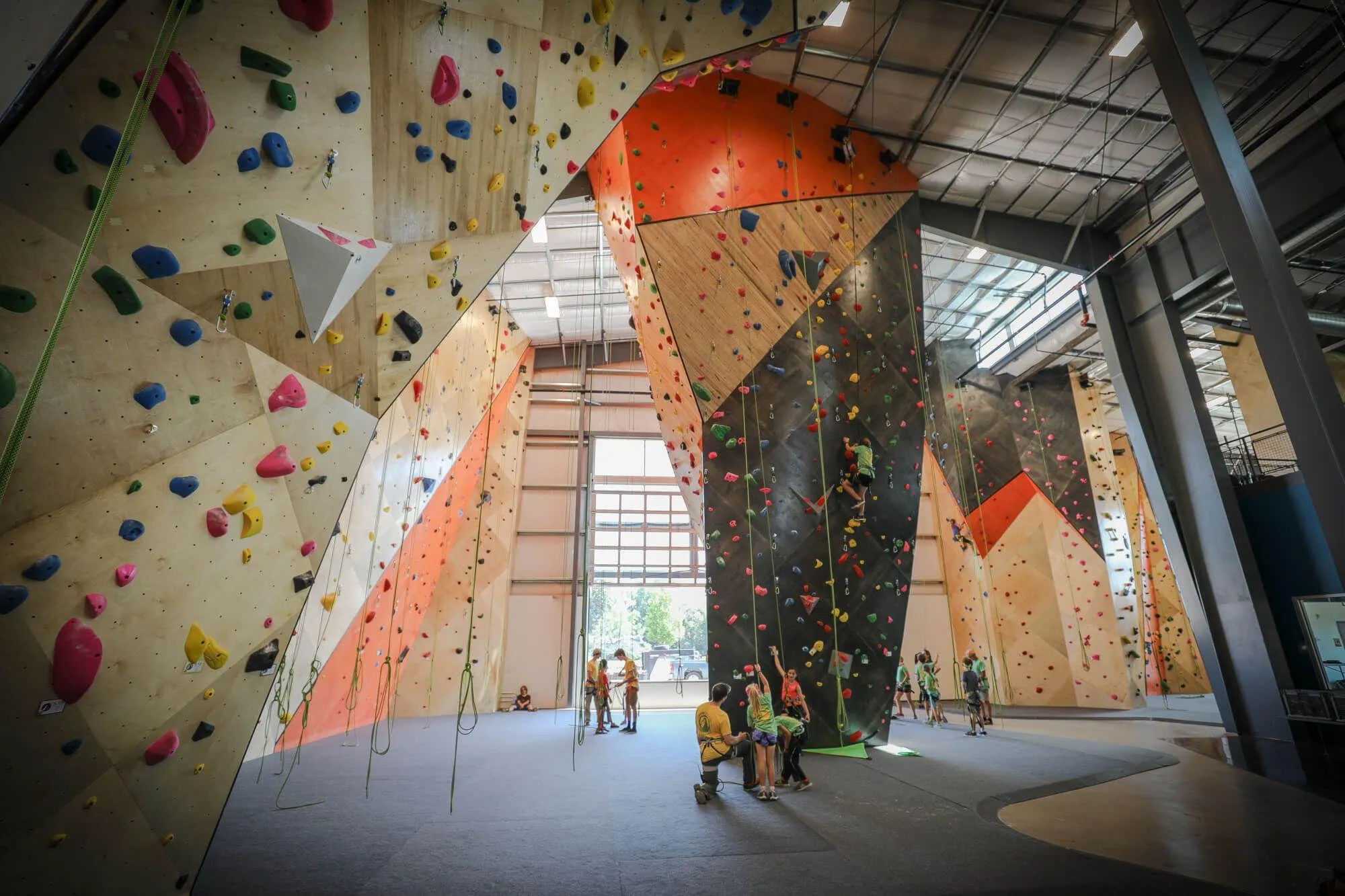 A view from the base of the large overhung MLM climbing wall structure looking towards The Spire and giving an impression on exactly how much wall area is dedicated to routes; this is just over 50% of it.