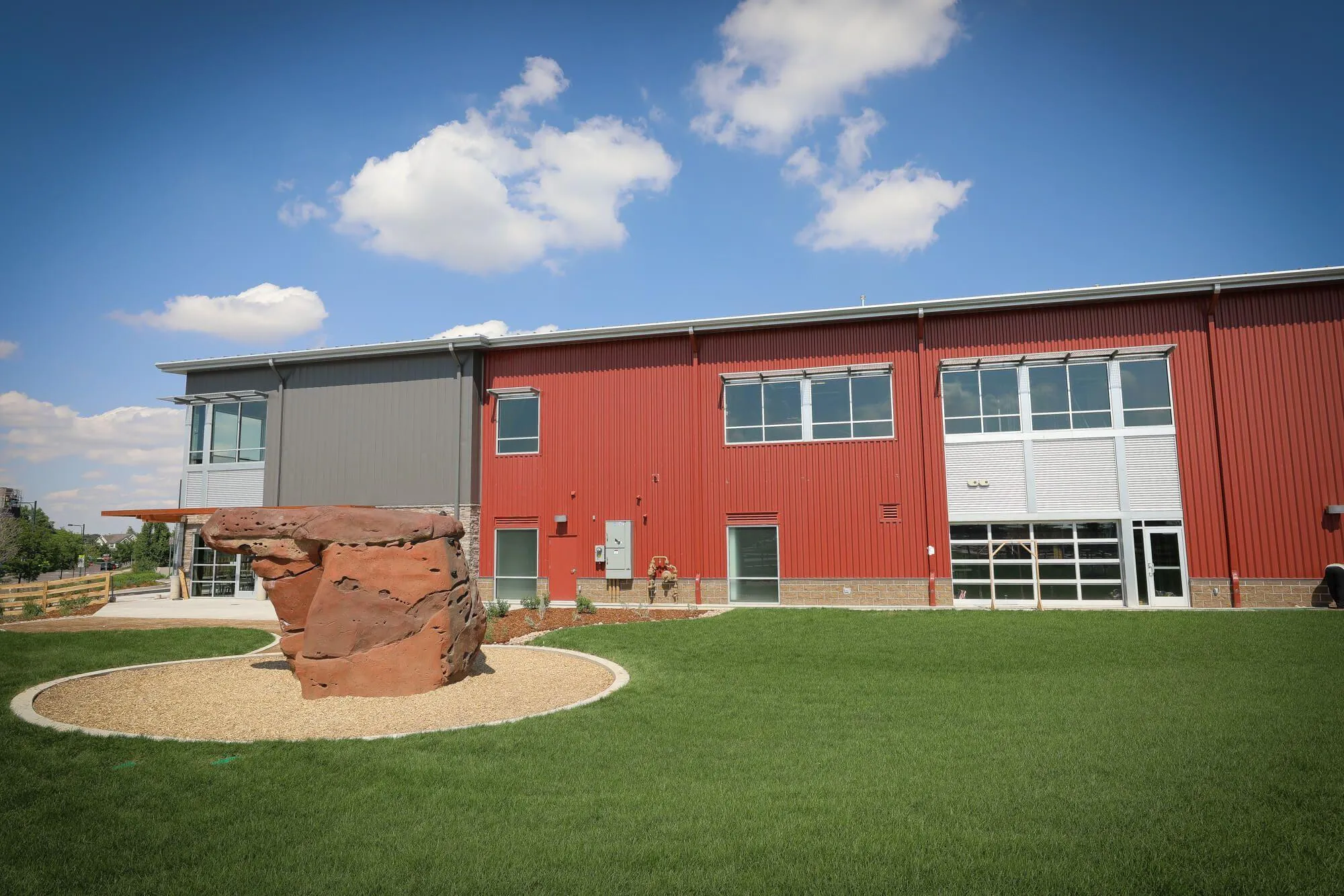 The landscape outside the Indoor Crag was utilized to provide an outdoor experience on bright & sunny Denver days! 
From the ground up, this building was designed to accommodate a climbing gym and is large enough to incorporate all the peripheral services like yoga studio, retail area and cafe.