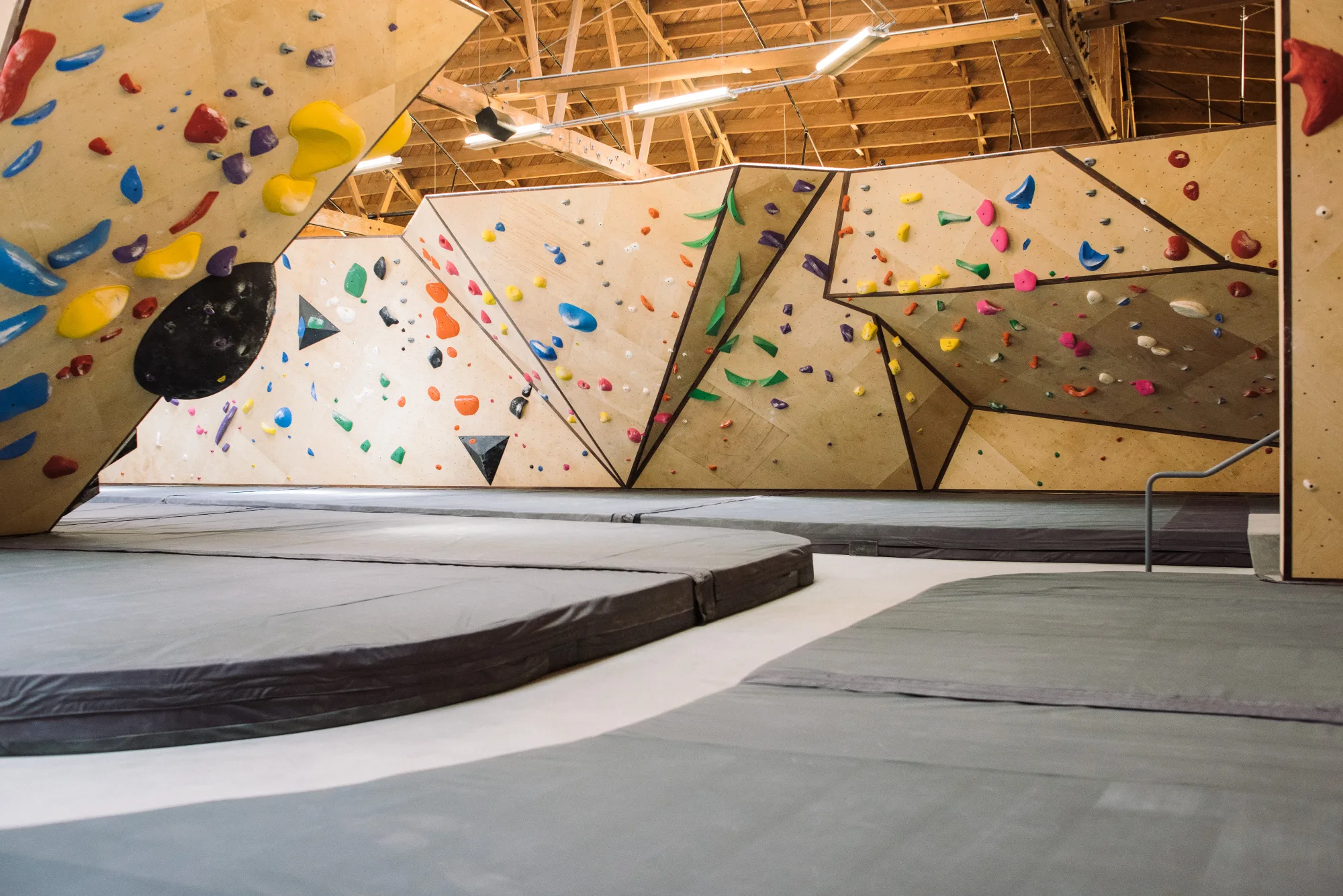 Custom climbing floor installed beneath a climbing wall